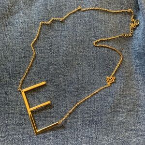 E gold toned necklace